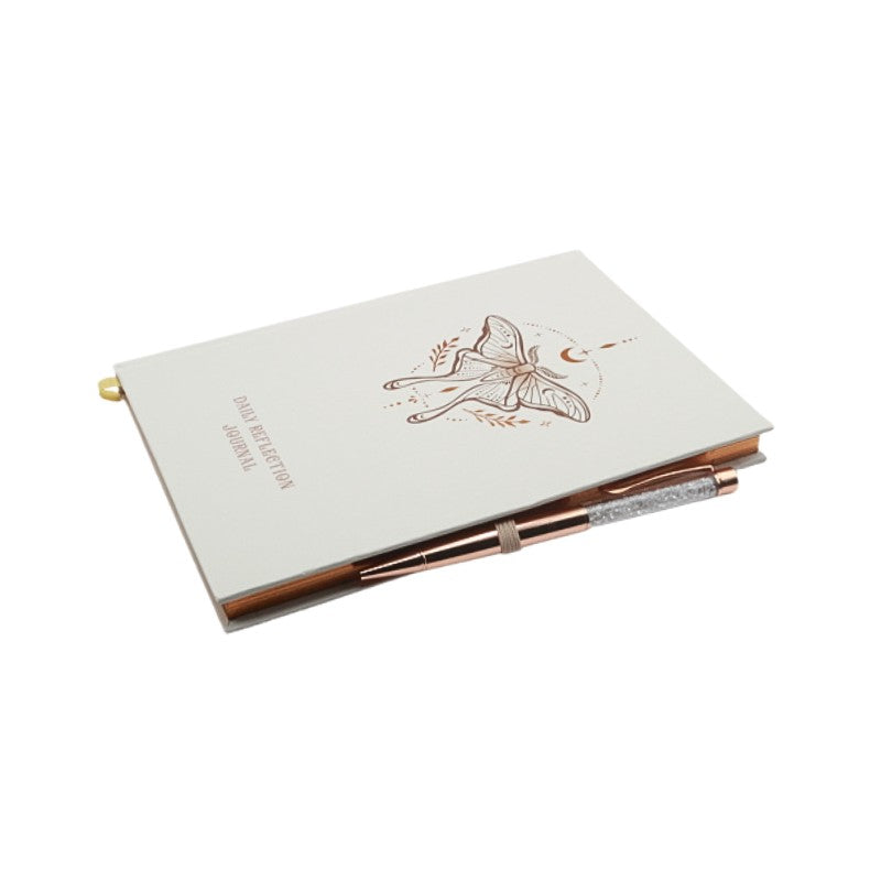 Journal with fairy design and pen on a white background