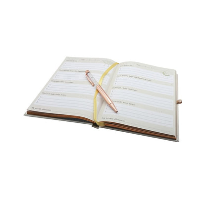 Open notebook with a pen on a white background