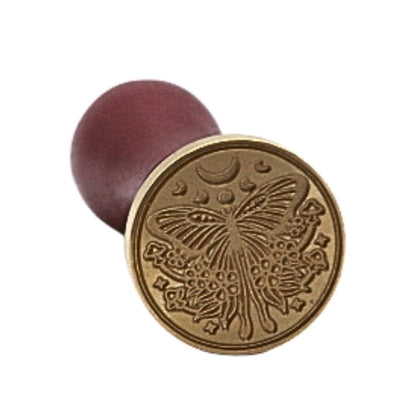 Brass wax seal with a lunar moth and moon phases on front