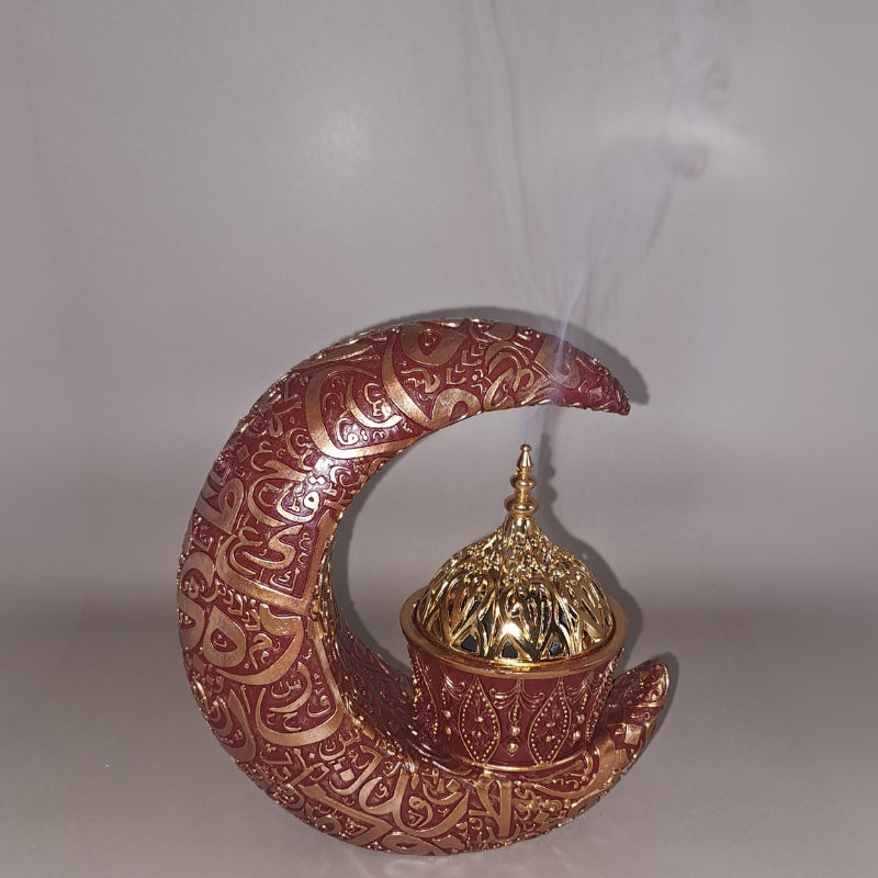 smoke billowing out of a crescent moon shaped incense burner