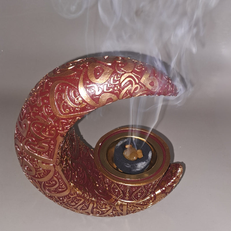 charcoal disc and frankincense resin in a crescent moon shaped incense burner