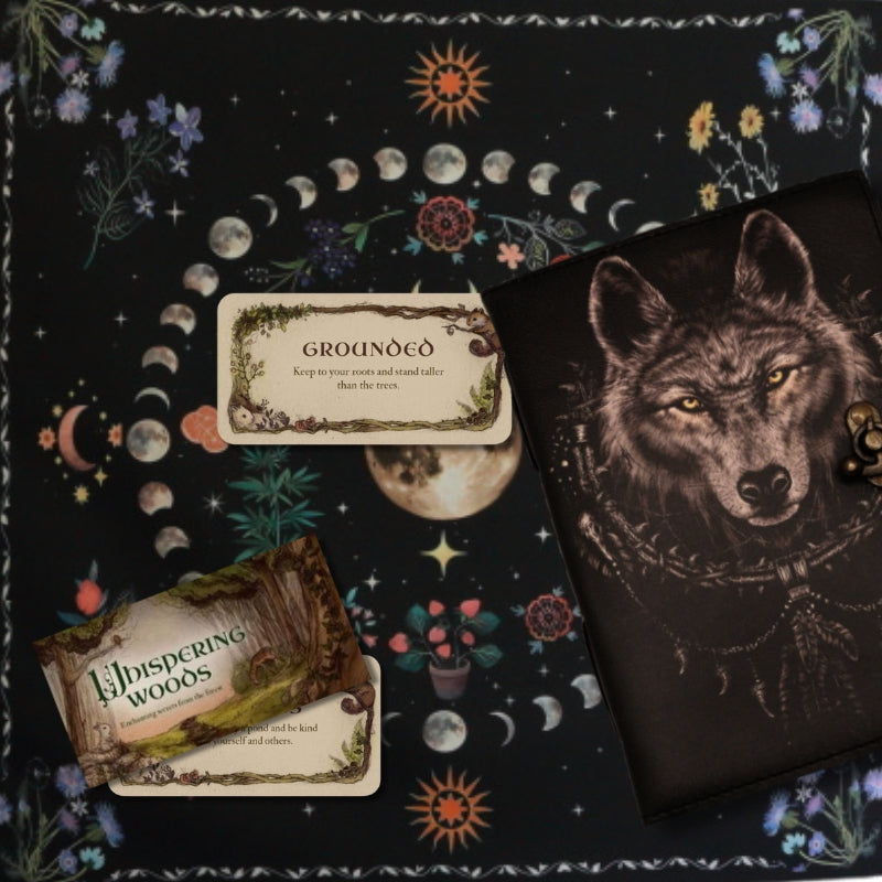 leather wolf journal and whispering woods tarot cards on a Floral Moon Phase Tarot Cloth