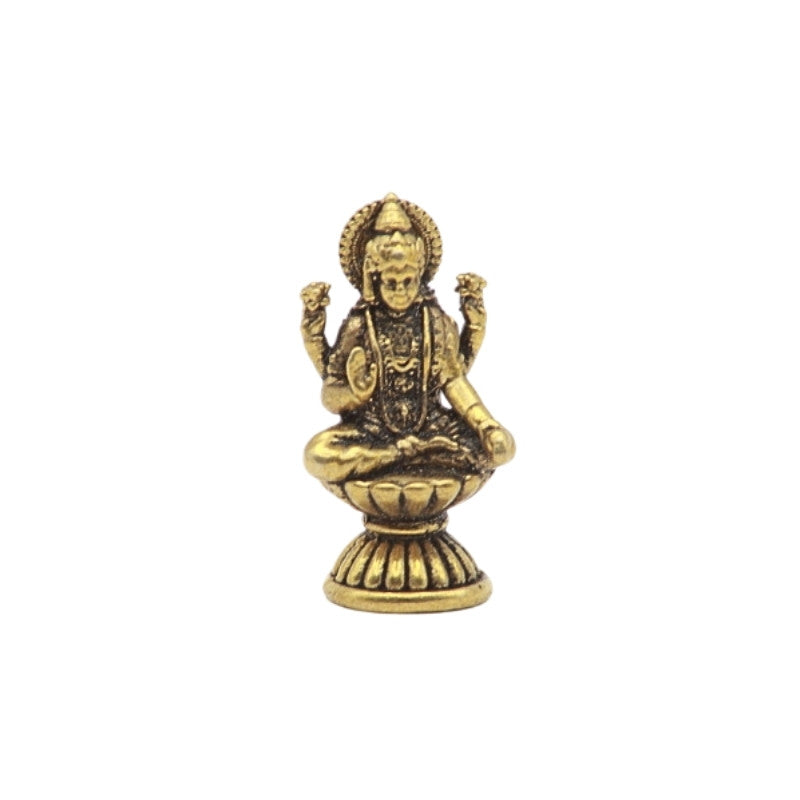 Brass  statue of a seated figure on a white background