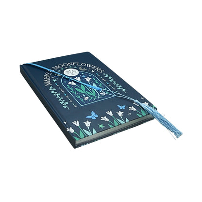 blue notebook with a floral moon design and title "magic & moonflowers"