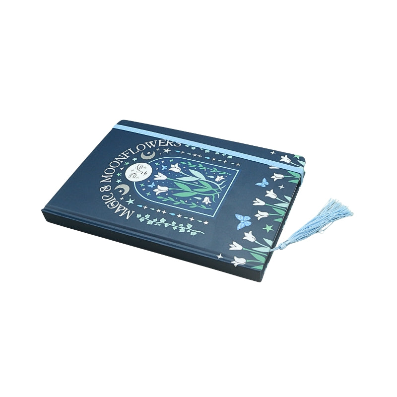 blue notebook with a floral moon design and title "magic & moonflowers"