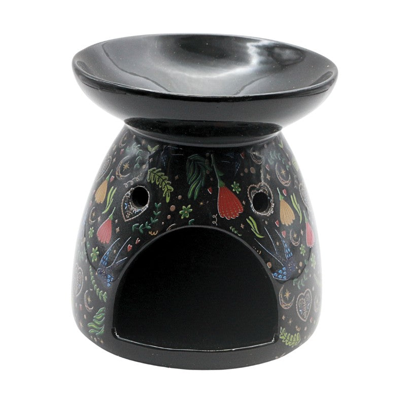 Decorative oil burner with colorful vegetable pattern on a white background