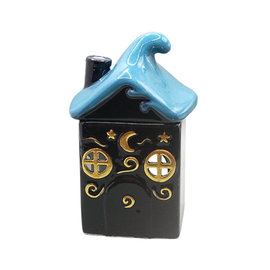 A small decorative house-shaped ceramic container or ornament with a dark blue body, a light blue wave-shaped roof, and gold celestial details including stars, a crescent moon, and window motifs, shown on a plain white background