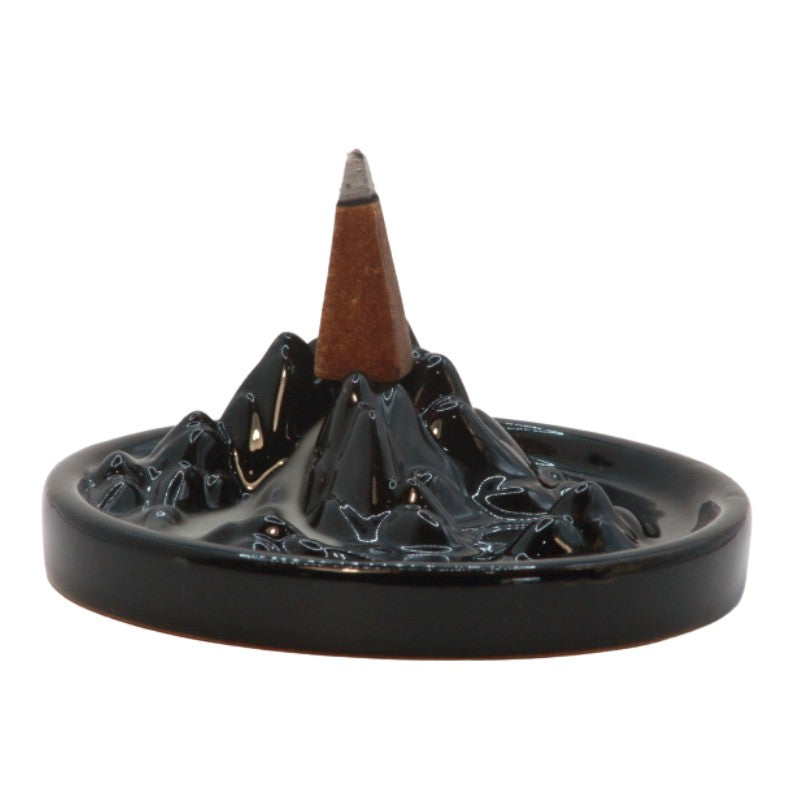 Incense cone on a black ceramic mountain incense burner