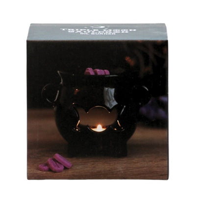 box featuring a black ceramic cauldron oil burner with a triple moon shape cut out on the front