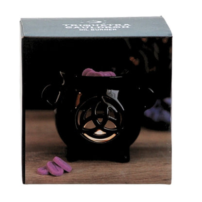 box featuring a black ceramic cauldron oil burner with a triquetra shape cut out on the front