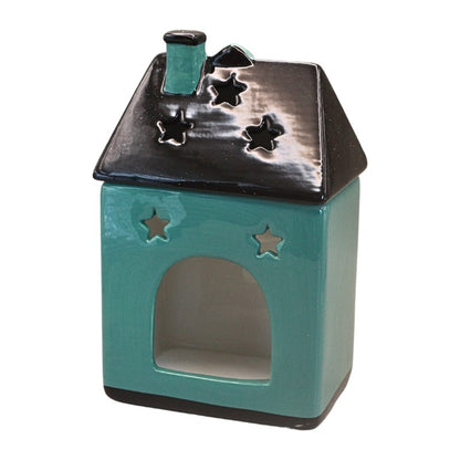 A small house-shaped ceramic candle holder or diffuser in glossy teal with a black roof and star-shaped cutouts, shown on a plain white background.