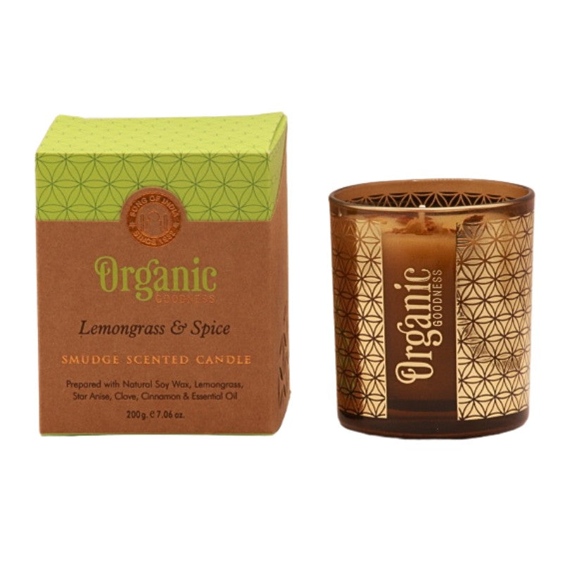 organic goodness candle box next to soy candle in a brown and gold votive candle jar