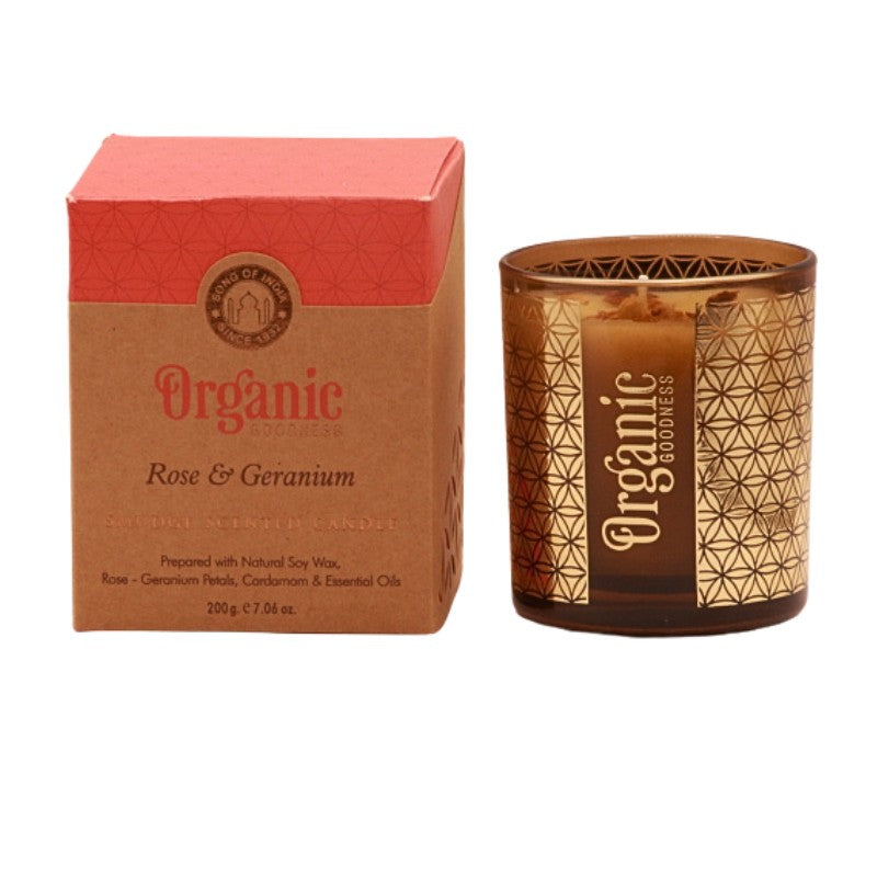 organic goodness candle box next to soy candle in a brown and gold votive candle jar