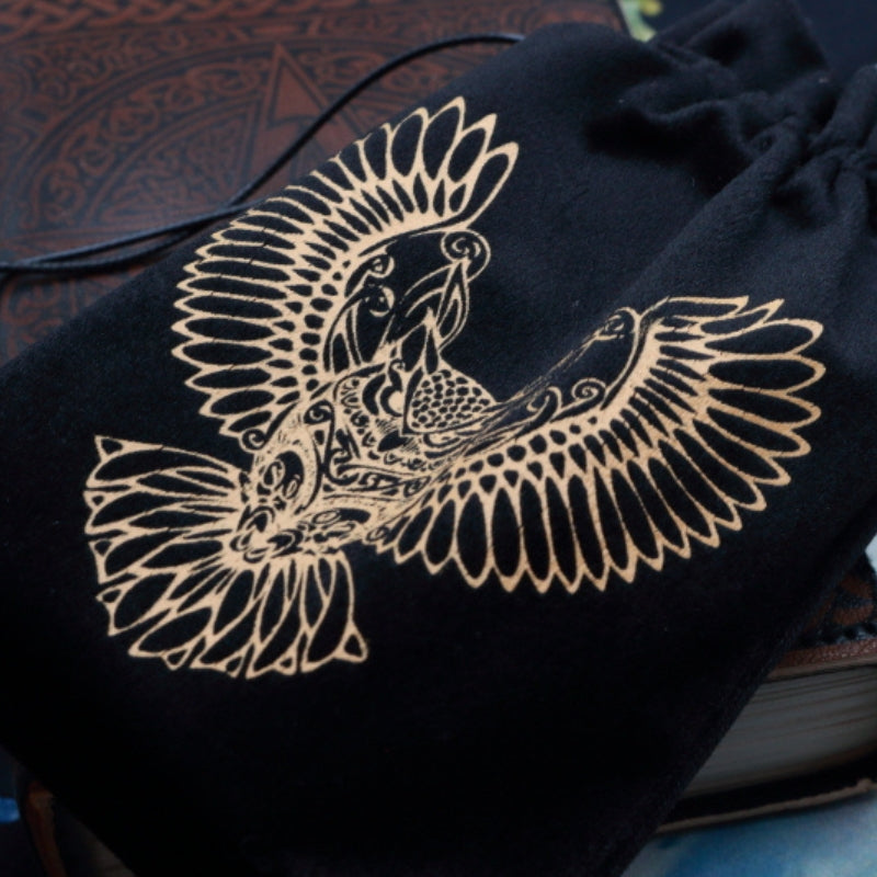 black and Gold Owl Tarot Bag for Tarot and Oracle Cards laying on a brown leather journal