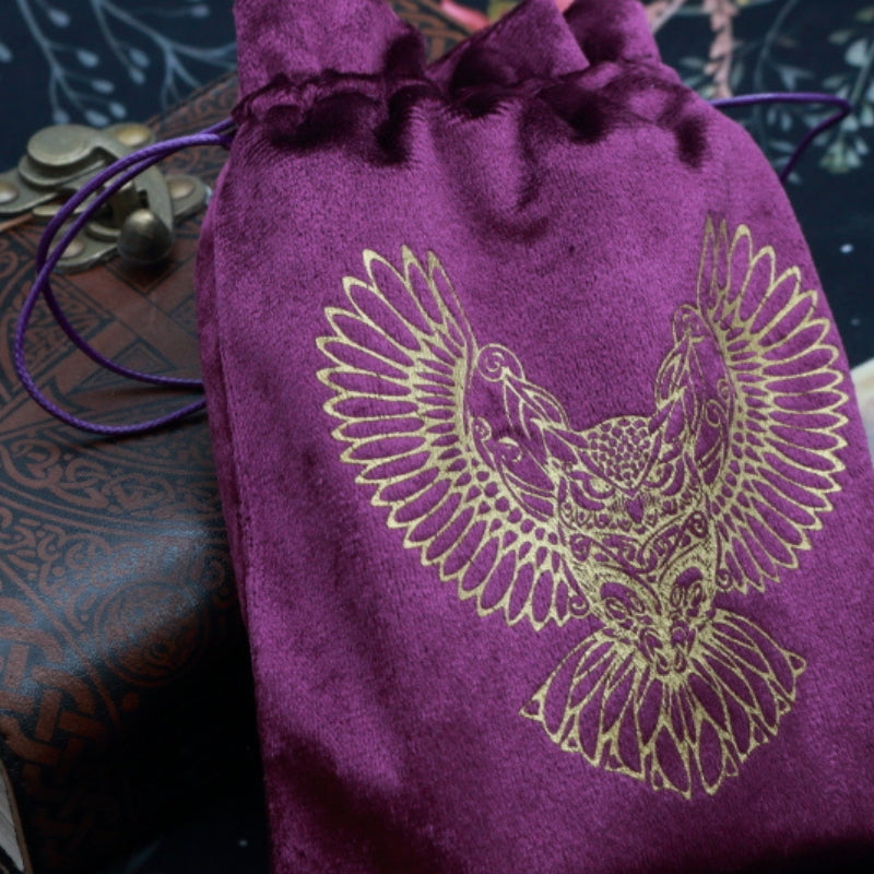 purple and Gold Owl Tarot Bag for Tarot and Oracle Cards laying on a brown leather journal