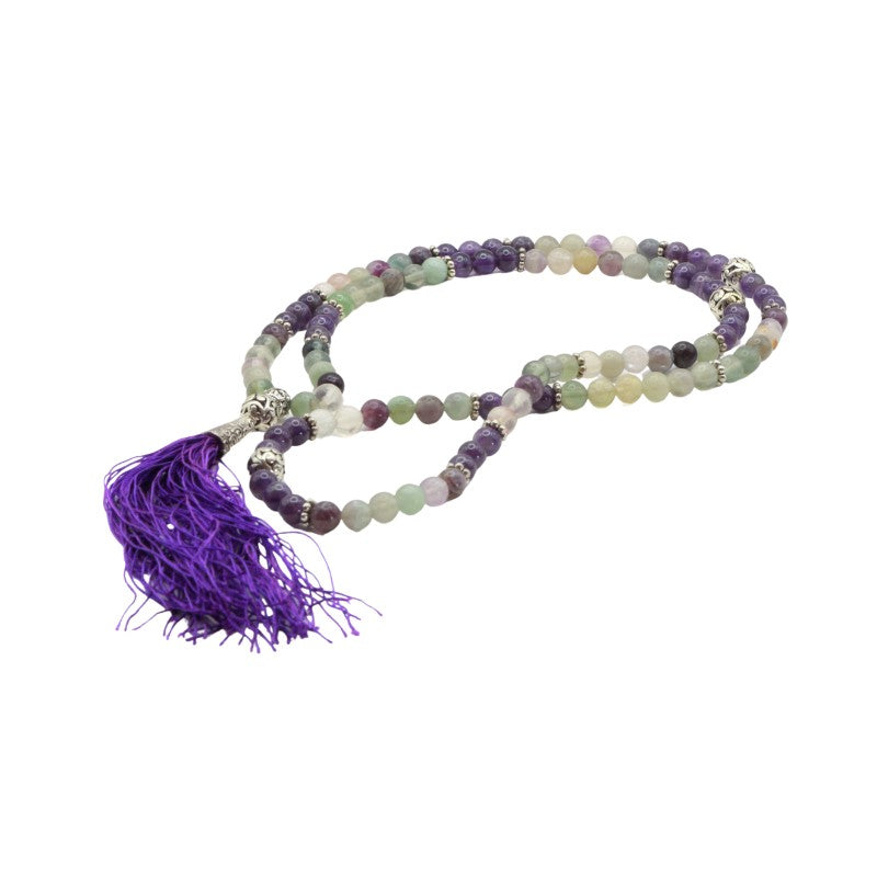 mala beads with multicolored beads and a purple tassel on a white background