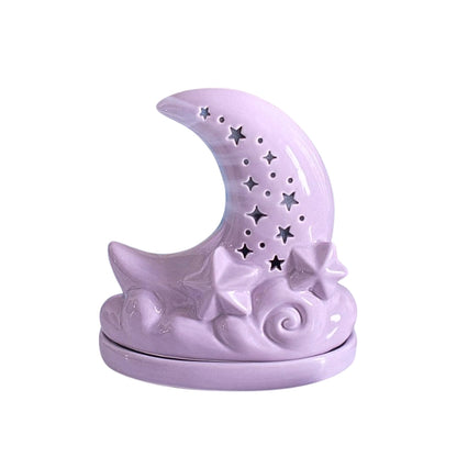 Purple ceramic moon shaped incense cone burner with star cut outs, on a white background