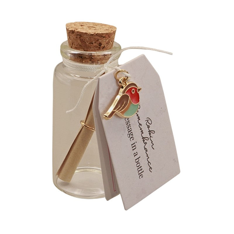 cork topped glass bottle with a paper scroll inside and bird charm tied around the top