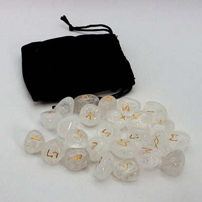 Set of crystal runes  with gold symbols on a white background, accompanied by a black drawstring bag.