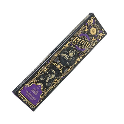 A rectangular box of Ritual brand incense sticks, featuring a black background with ornate gold illustrations and purple accents, including a snake and moon design.