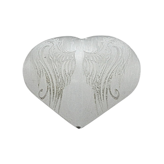 selenite heart with angel wings engraved on top on a white background