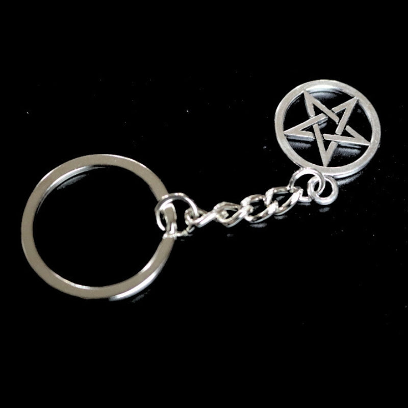silver coloured key ring with a pentacle (5 pointed star within a circle) joined to a silver ring by a silver chain