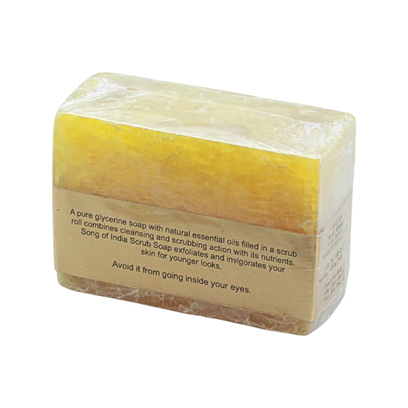 A rectangular bar of yellow scrub soap wrapped in clear plastic with a brown paper label, shown on a plain white background.