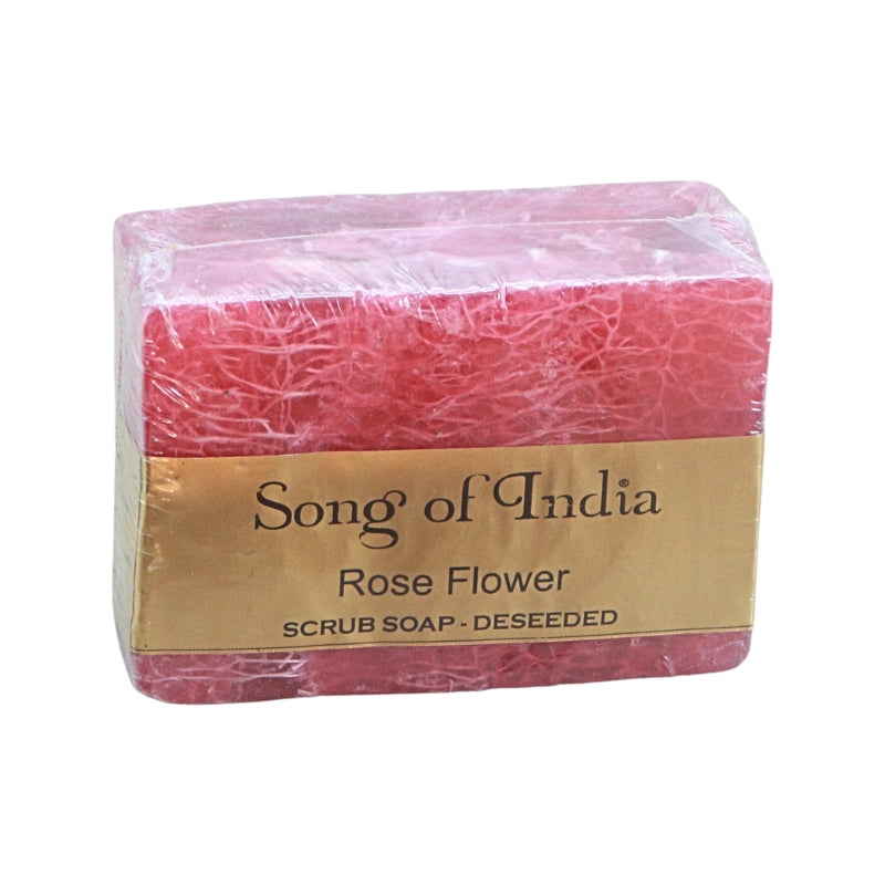 A rectangular bar of deeseed rose flower scrub soap by Song of India, wrapped in clear plastic with a gold paper label, on a white background.