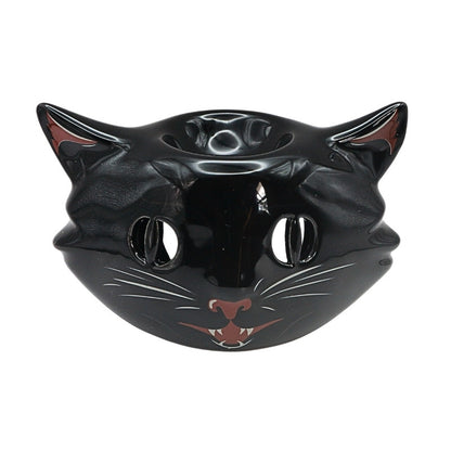 black ceramic oil burner with a cat face on front