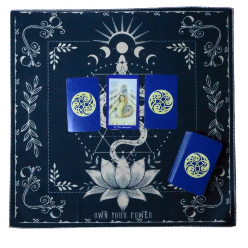 tarot cloth with snake and lotus design with 3 cards laid out on top