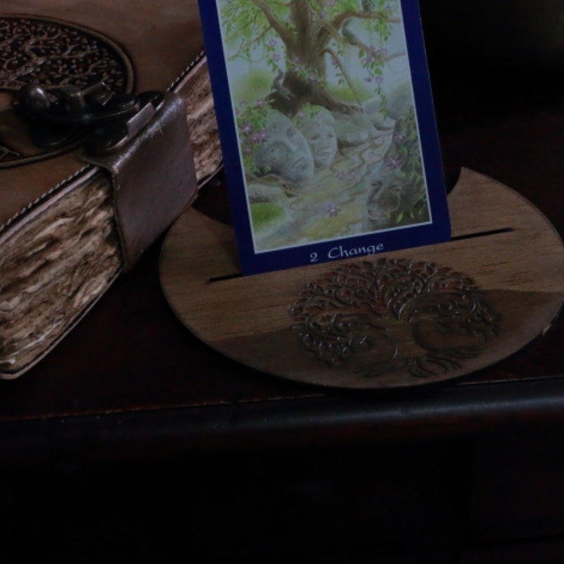 Tree Of Life Tarot Card Holder holding a tarot card. next to a yggdrasil journal
