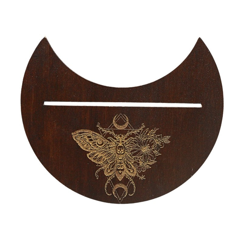 Wooden crescent moon-shaped object with intricate butterfly design on a white background