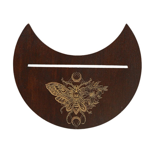 Wooden crescent moon-shaped object with intricate butterfly design on a white background