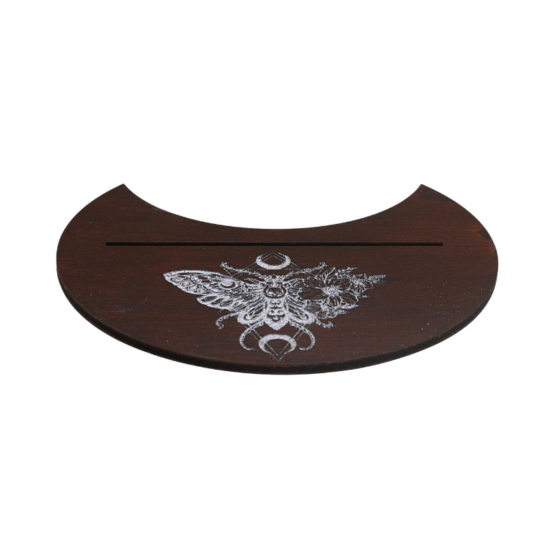 A dark brown wooden half-circular tray with a white engraved moth and moon design, featuring a horizontal slot across the top, shown on a plain white background.