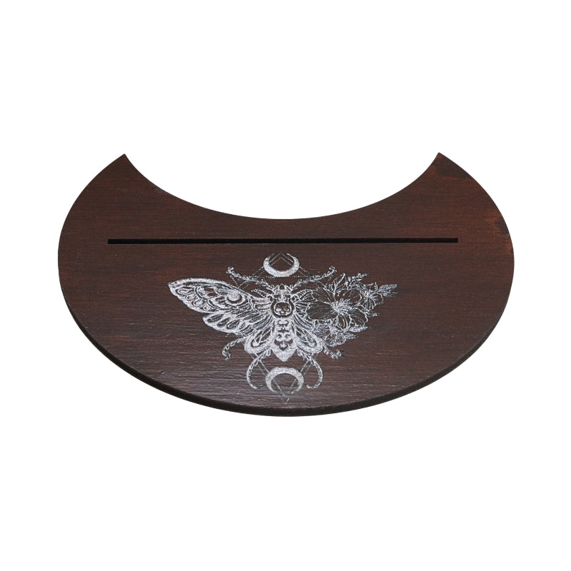 A dark brown wooden half-circular tray with a white engraved moth and moon design, featuring a horizontal slot across the top, shown on a plain white background.