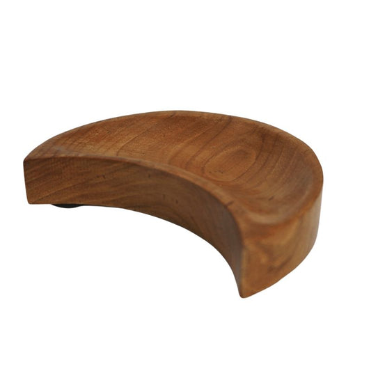 A carved teak wooden bowl in the shape of a crescent moon