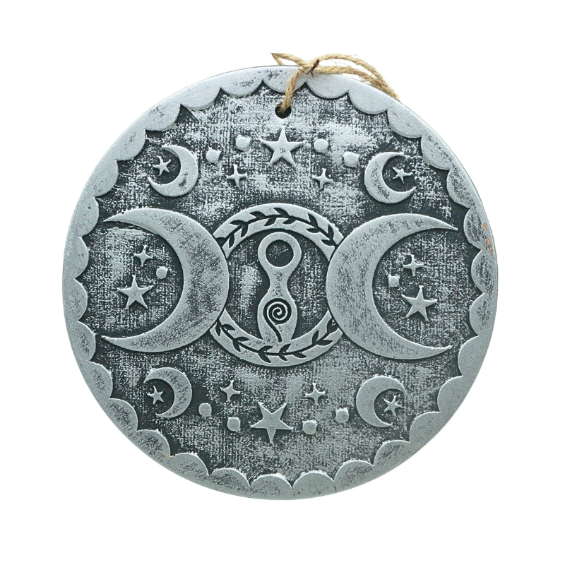 silver coloured terracotta wall plaque with image of a spiral goddess in a circle ith two crescent moons at either side