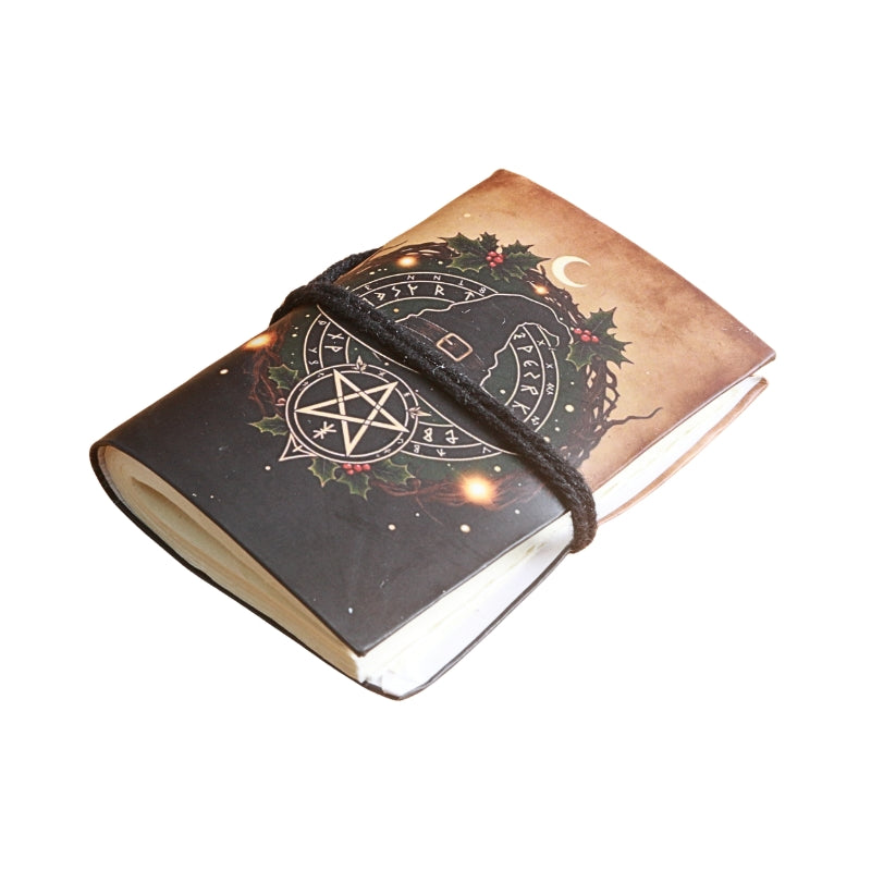 small notebook with brown tie and image of a witches hat and pentacle, on  a white background