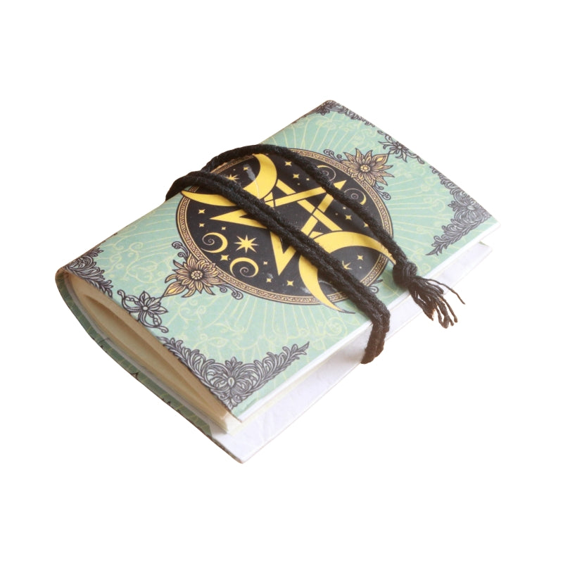 small notebook with brown tie and image of a pentacle and crescent moons either side, on  a white background