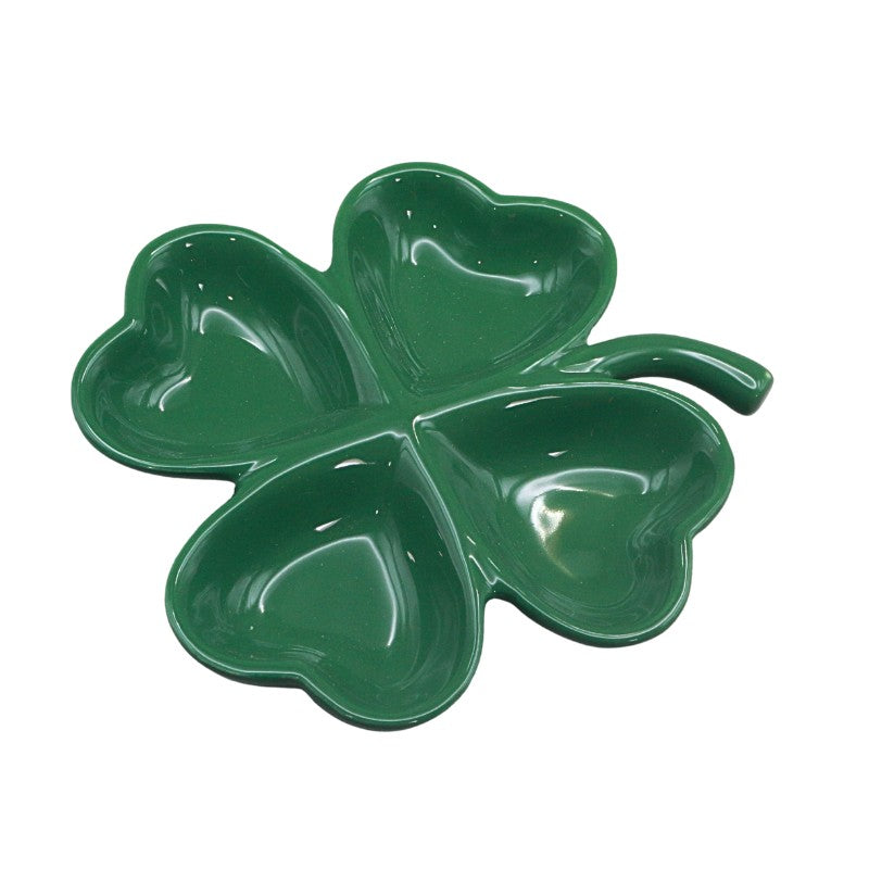 Green four-leaf clover-shaped dish on a white background