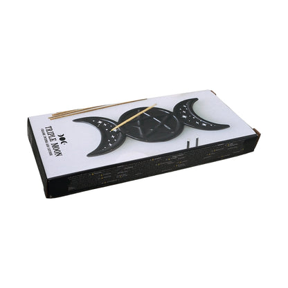 A boxed set of Triple Moon Incense holder, featuring a white and black box with illustrations of the triple moon phases and a few incense sticks visible on top, set against a plain white background.