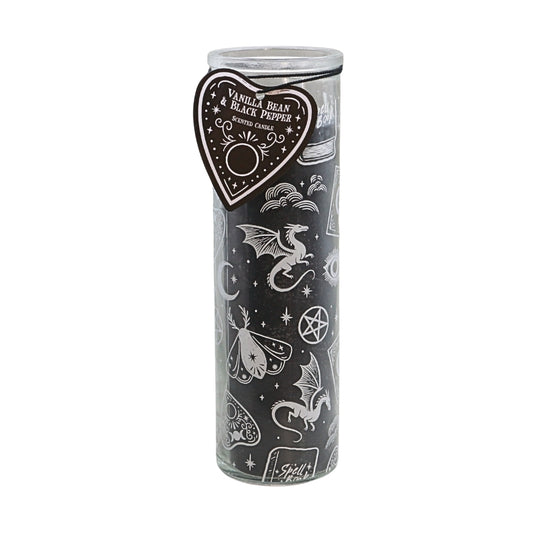 A tall glass jar candle with a black wax fill and white occult-themed illustrations, featuring a heart-shaped paper tag that reads 'Vanilla Bean Black Pepper' and 'Soul Fire'.
