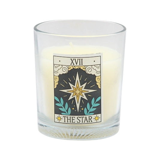 Candle in a glass holder with a tarot card design featuring the 'The Star' card.