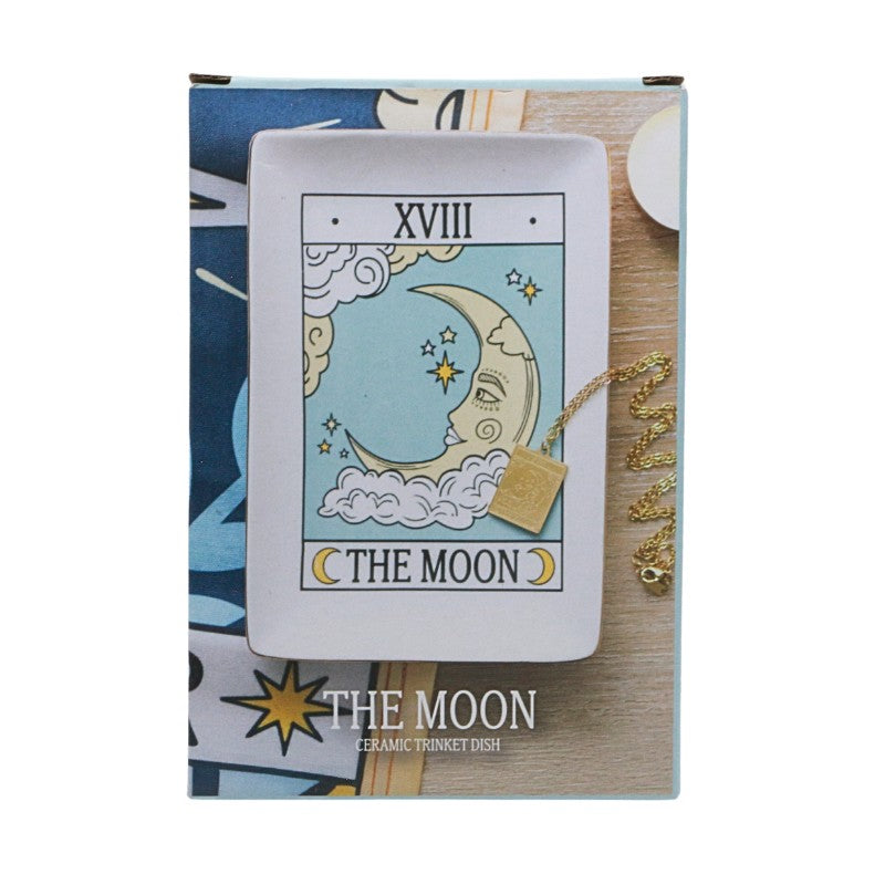 Ceramic trinket dish with 'The Moon' tarot card design on a wooden surface.