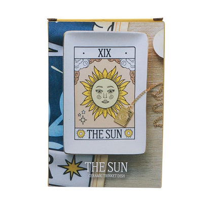 Decorative trinket dish with 'The Sun' tarot card design on a wooden surface.