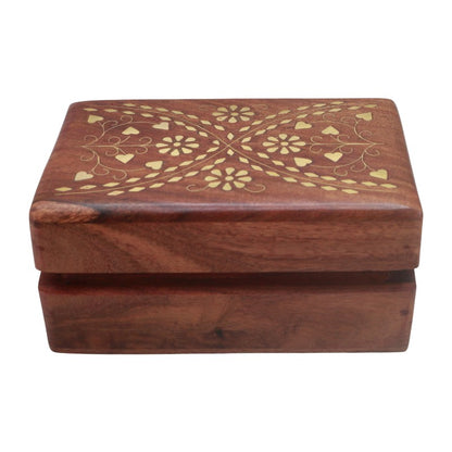A rectangular wooden keepsake box with a hinged lid, featuring a warm reddish-brown wood grain and a gold-colored floral inlay pattern on the top surface, shown against a plain white background.