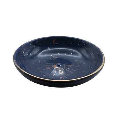 Decorative incense bowl with celestial design on a white background