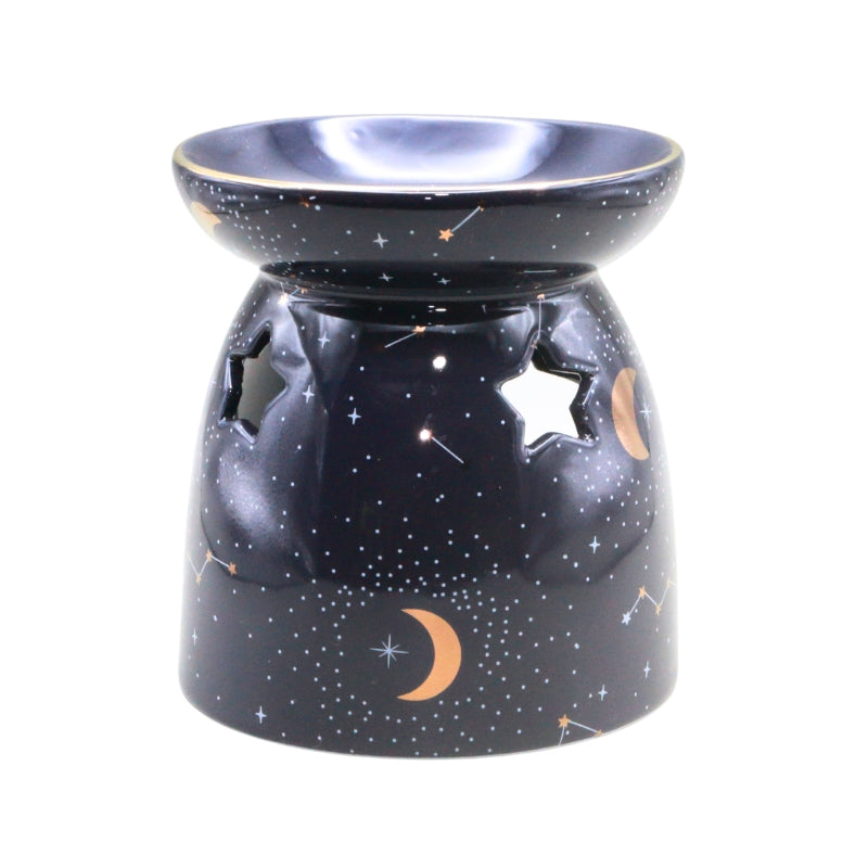 A ceramic oil burner lamp with a starry night sky design, featuring a dark blue base decorated with white stars, crescent moons, and constellations, with star-shaped cutouts on the side.
