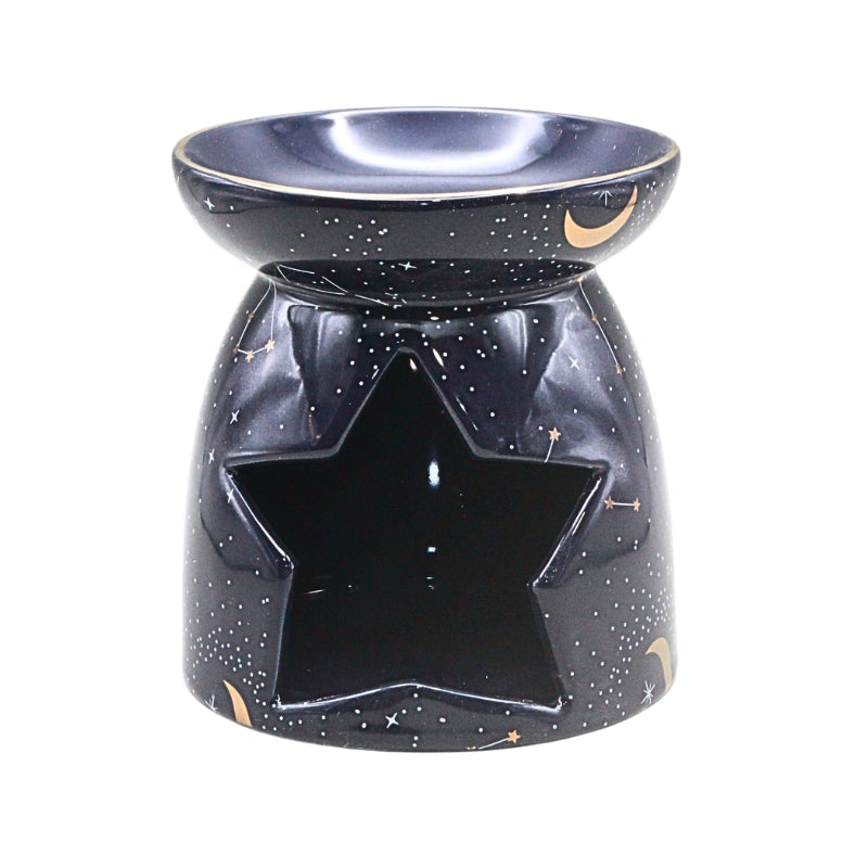 A ceramic oil burner and candle holder with a star-shaped cutout on the front, decorated with a black starry sky pattern and small gold crescent moon accents, shown on a plain white background.
