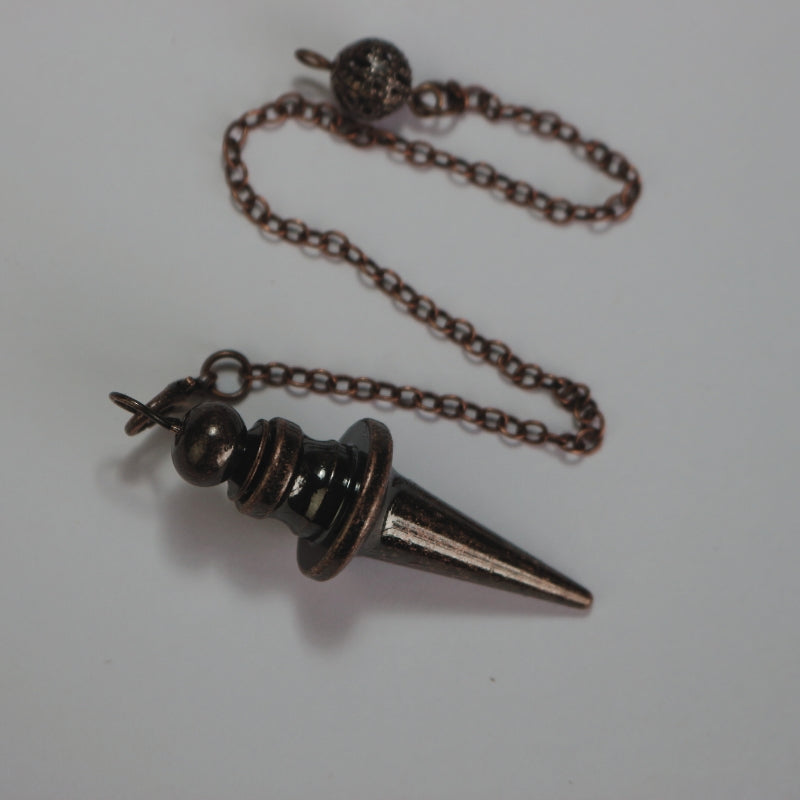 Bronze Coloured conical pendulum attached to a chain with a ball at the end